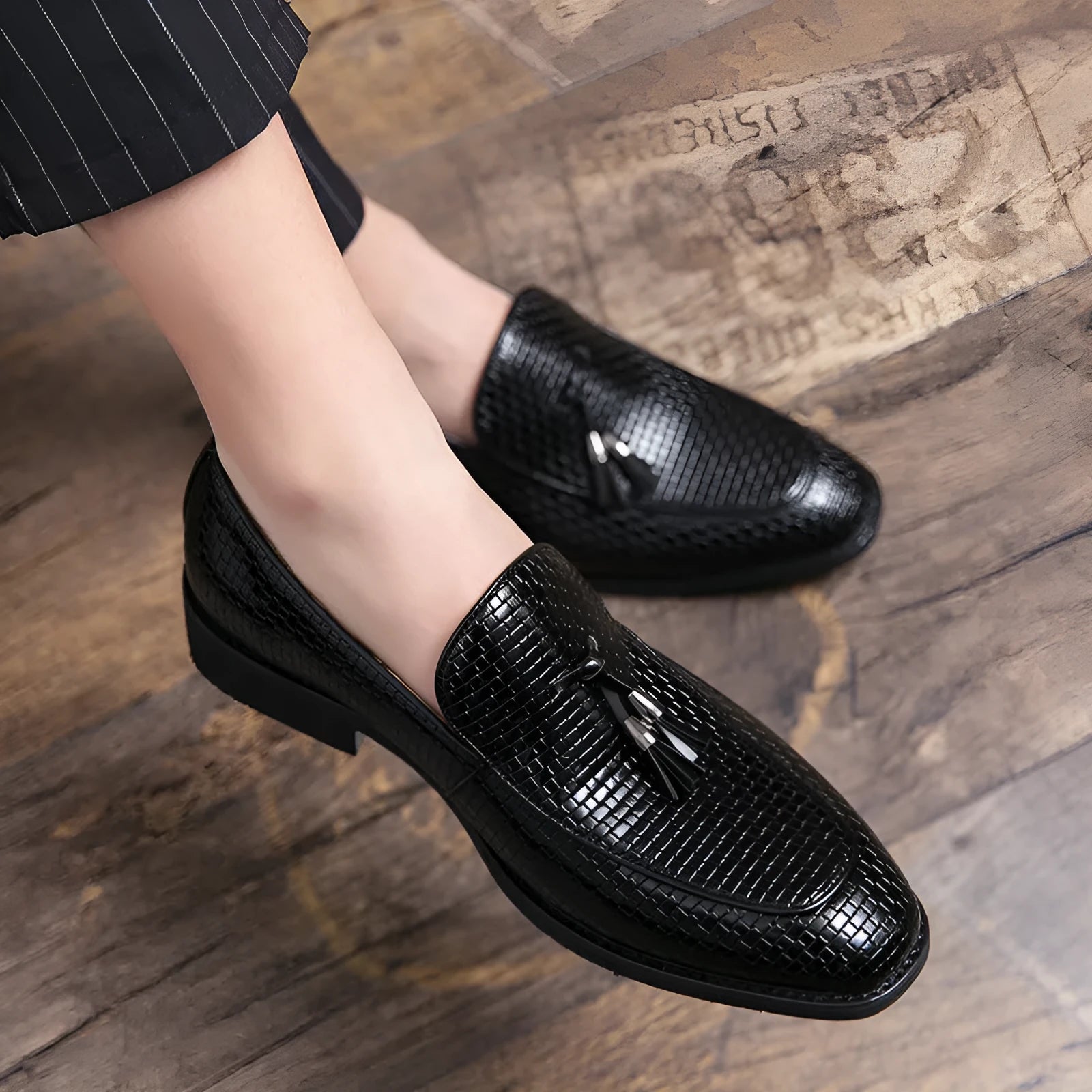 Men's black pointed toe slip on loafers with tassel detail on artificial PU leather upper