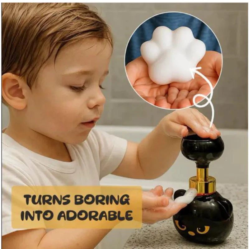 Black plastic cartoon cat-shaped foam soap dispenser on a countertop.