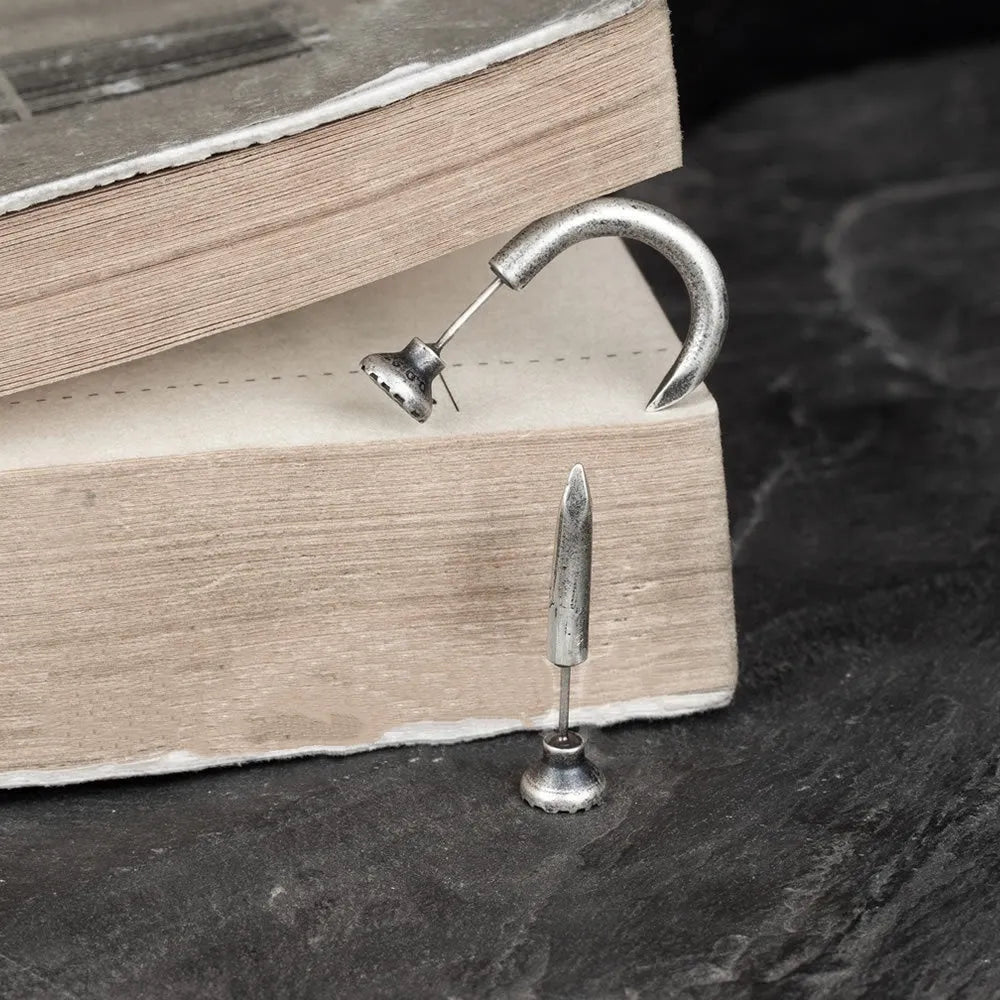 Sterling silver nail stud earrings in straight and curved punk styles on ear hooks