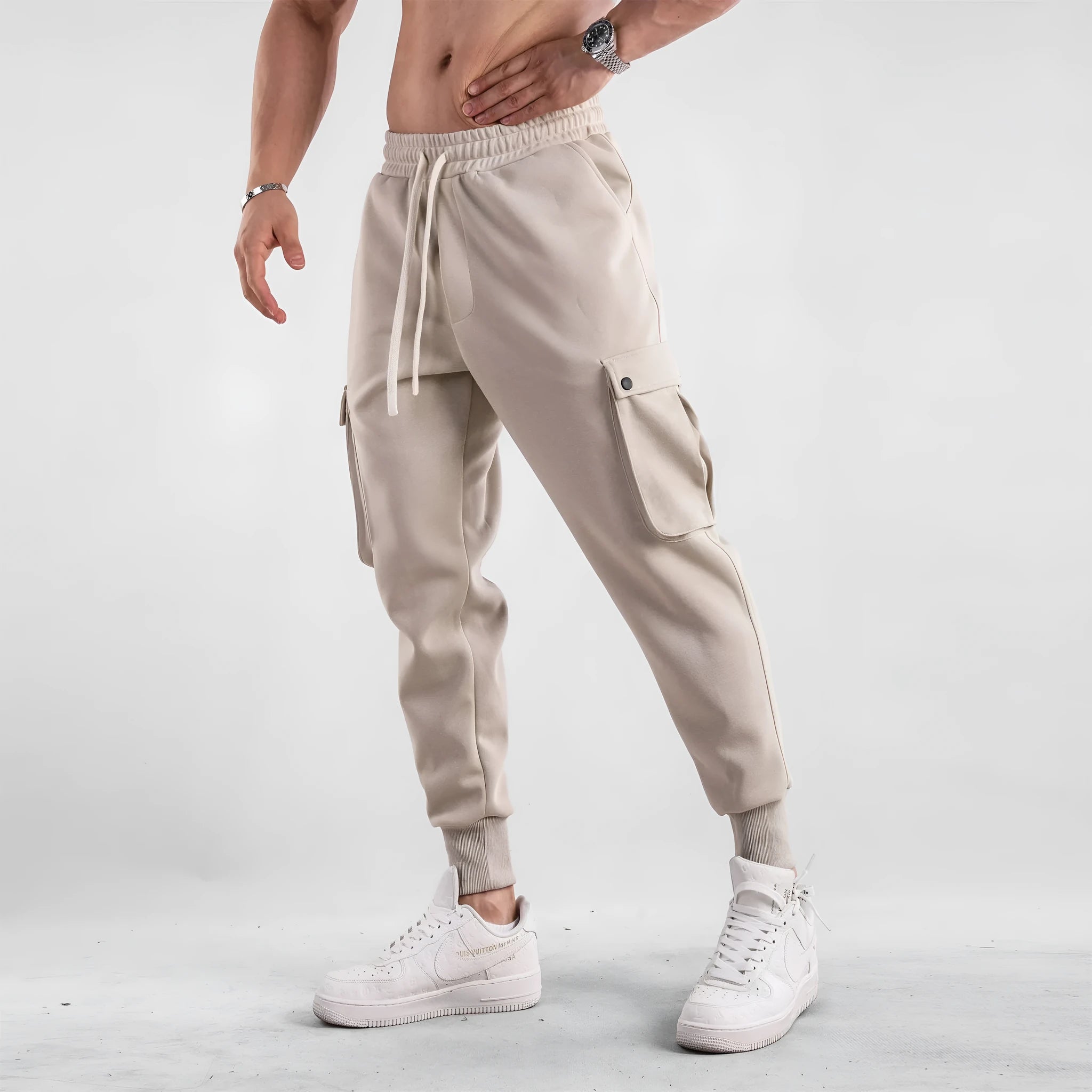 Men's loose cotton sports trousers with ankle tie detail and multiple pockets in apricot colour