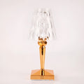 Portable rose gold touch control night light with acrylic lamp holder on a table.