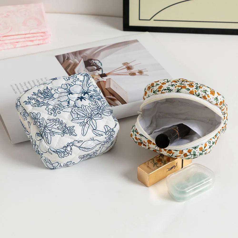 Floral print polyester key storage bag with sewing thread decoration in pink small flower colour.