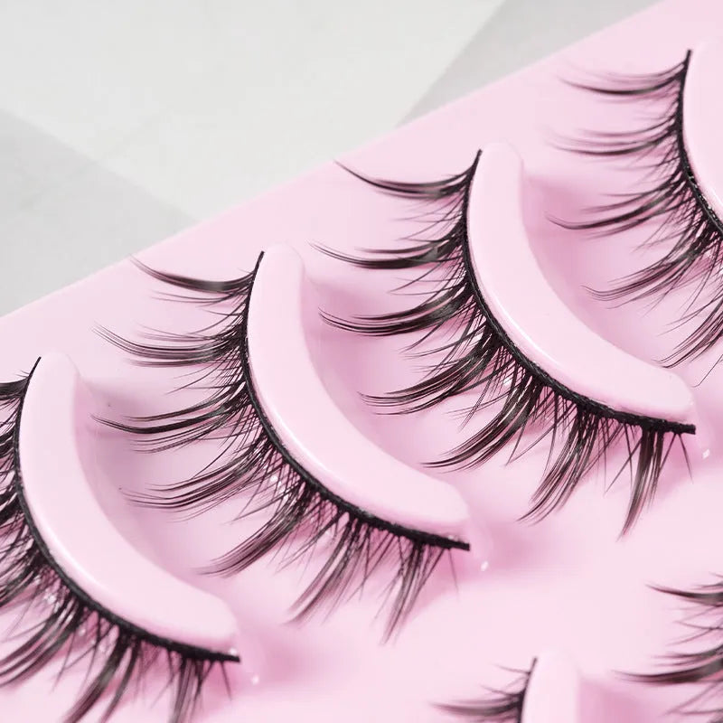 Pack of manga-style false eyelashes showing natural wispy lashes on a black plastic band.