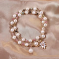 Women's double circle crystal bracelet with flower-shaped crystal detail in Strawberry Quartz colour