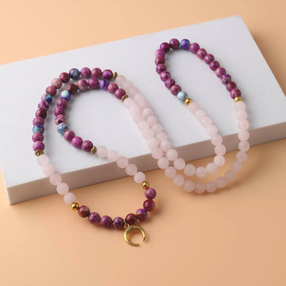 Pink crystal round Emperor Stone beads pendant necklace on a casual unisex cord, approximately 45 cm long