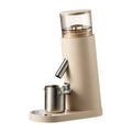 Automatic stainless steel coffee grinder machine in beige colour on a countertop.