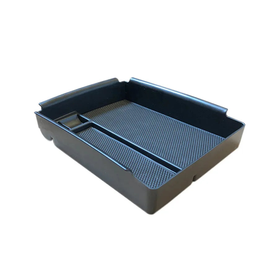 Black ABS plastic wireless charging base box for QI smartphones on a desk