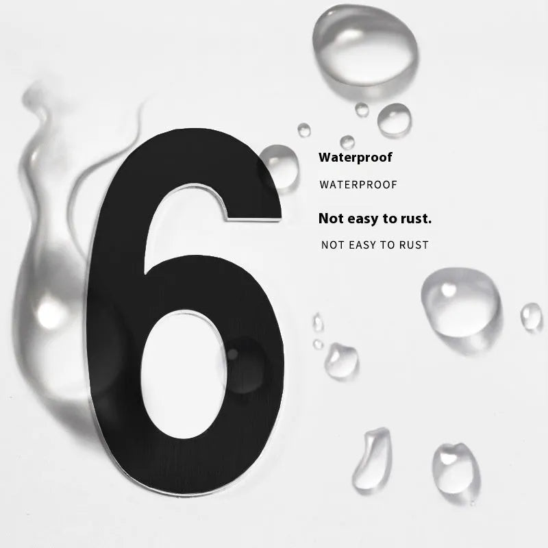 Black stainless steel adhesive-backed house number or letter, 7.5cm tall, for outdoor door or wall.