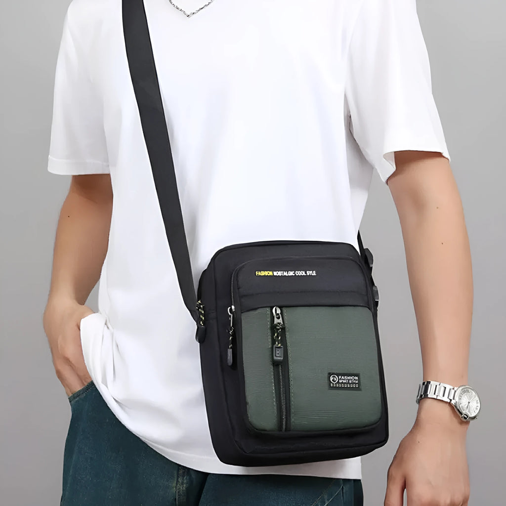 Men's nylon crossbody messenger bag in green showing shoulder strap and sewing thread detailing