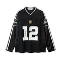 Men's black and white long-sleeved v-neck top with digital print pattern, loose fit.