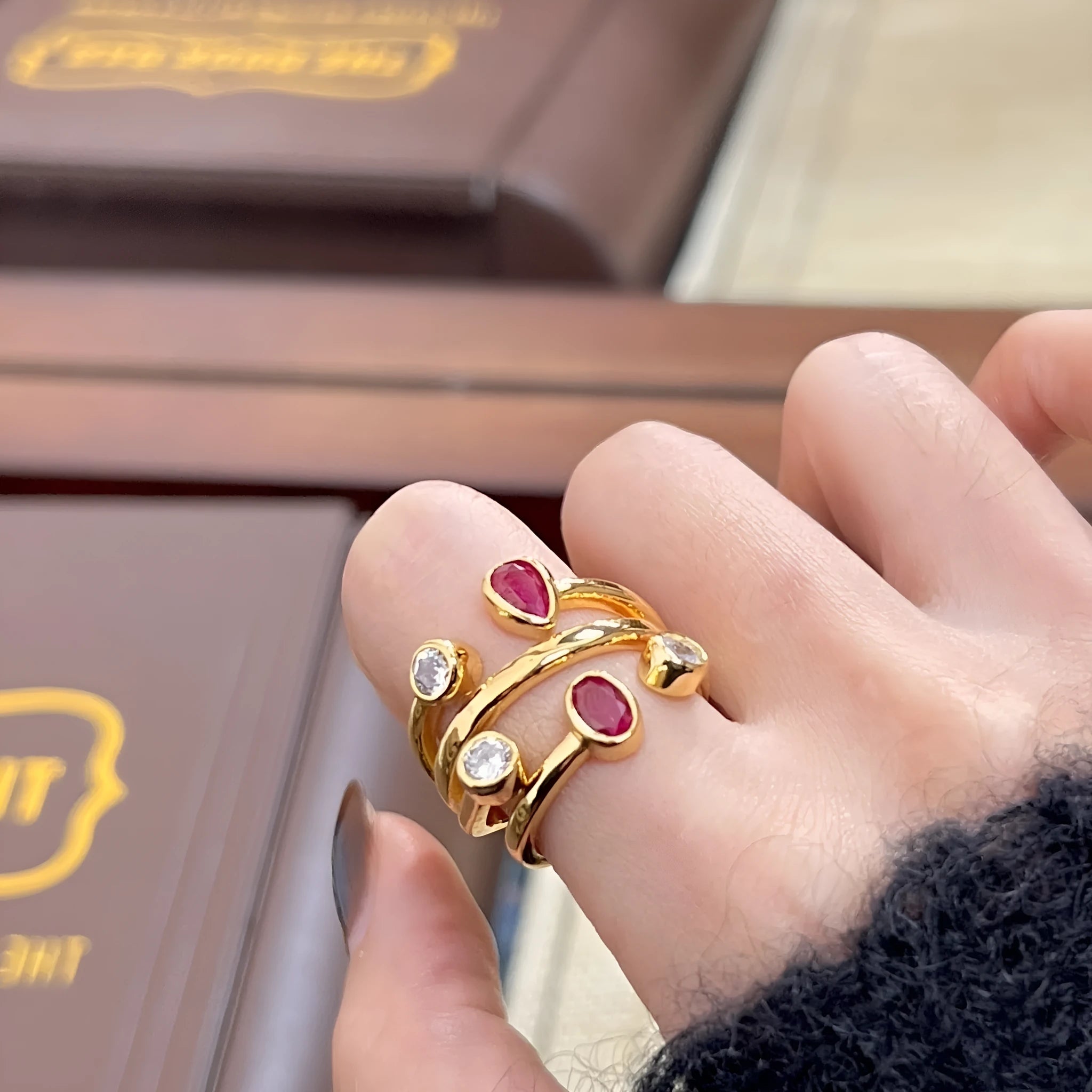 Geometric double-headed copper ring with irregular cross design and diamonds in two-tone colours.