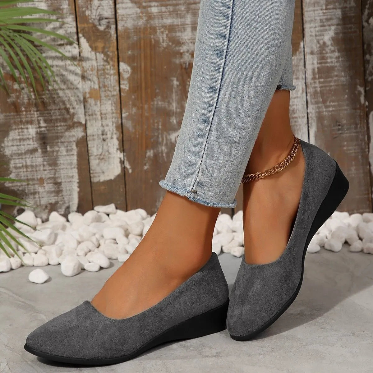 Women's low-heel suede wedge pump in light brown with a round toe and rubber sole.