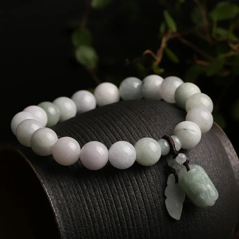 Natural emerald green jade hanging bracelet with Maitreya Buddha design on a geometric shape.