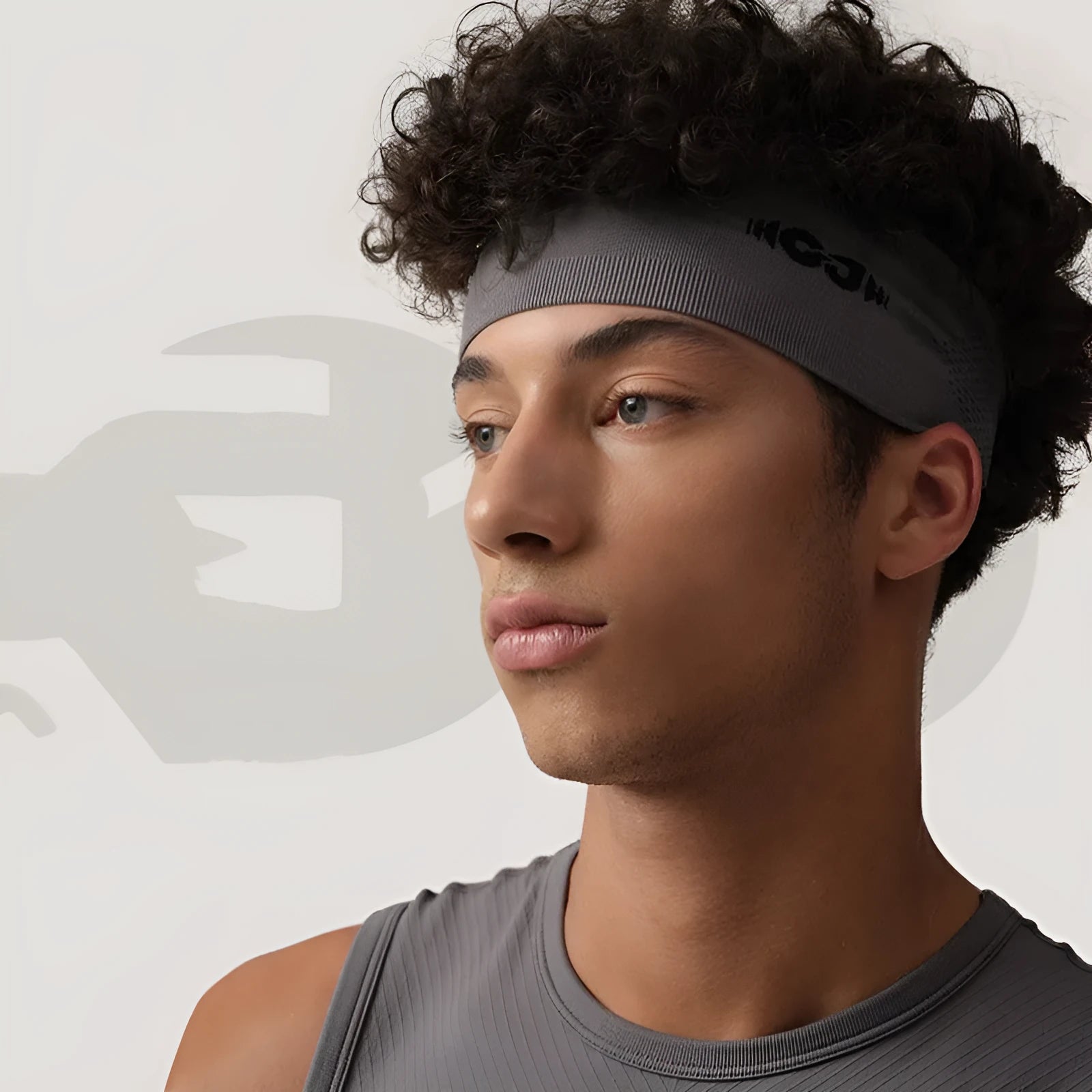 Seamless knitted sport headband for men and women in black, shown worn during exercise.
