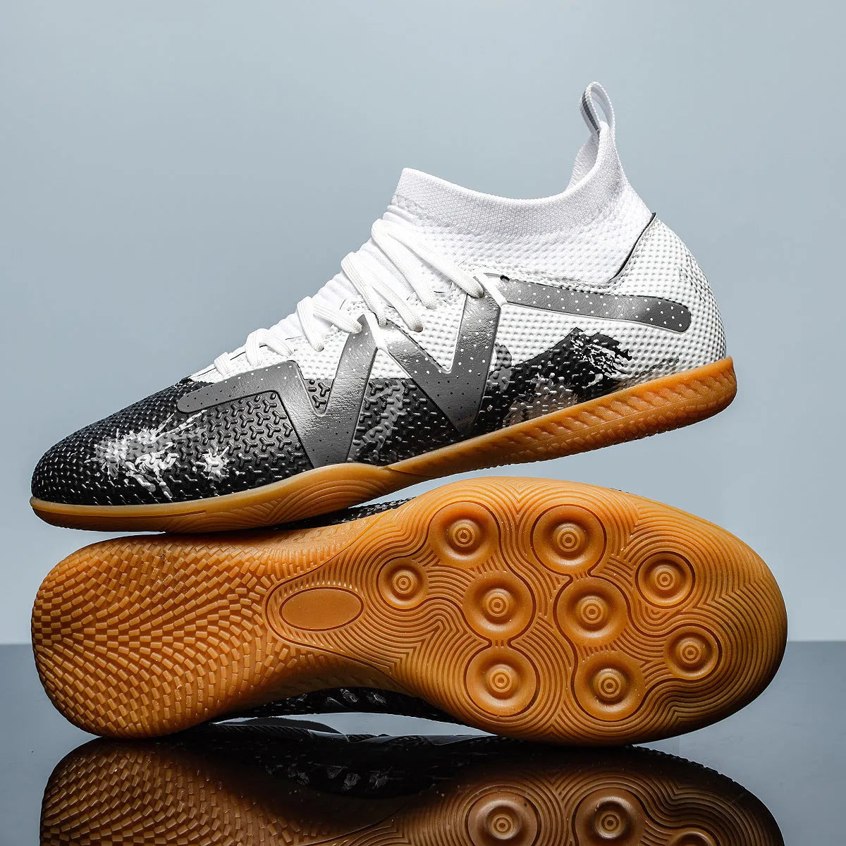 Adult low-top football boots with a PVC upper and rubber studded outsole, shown in black and yellow.