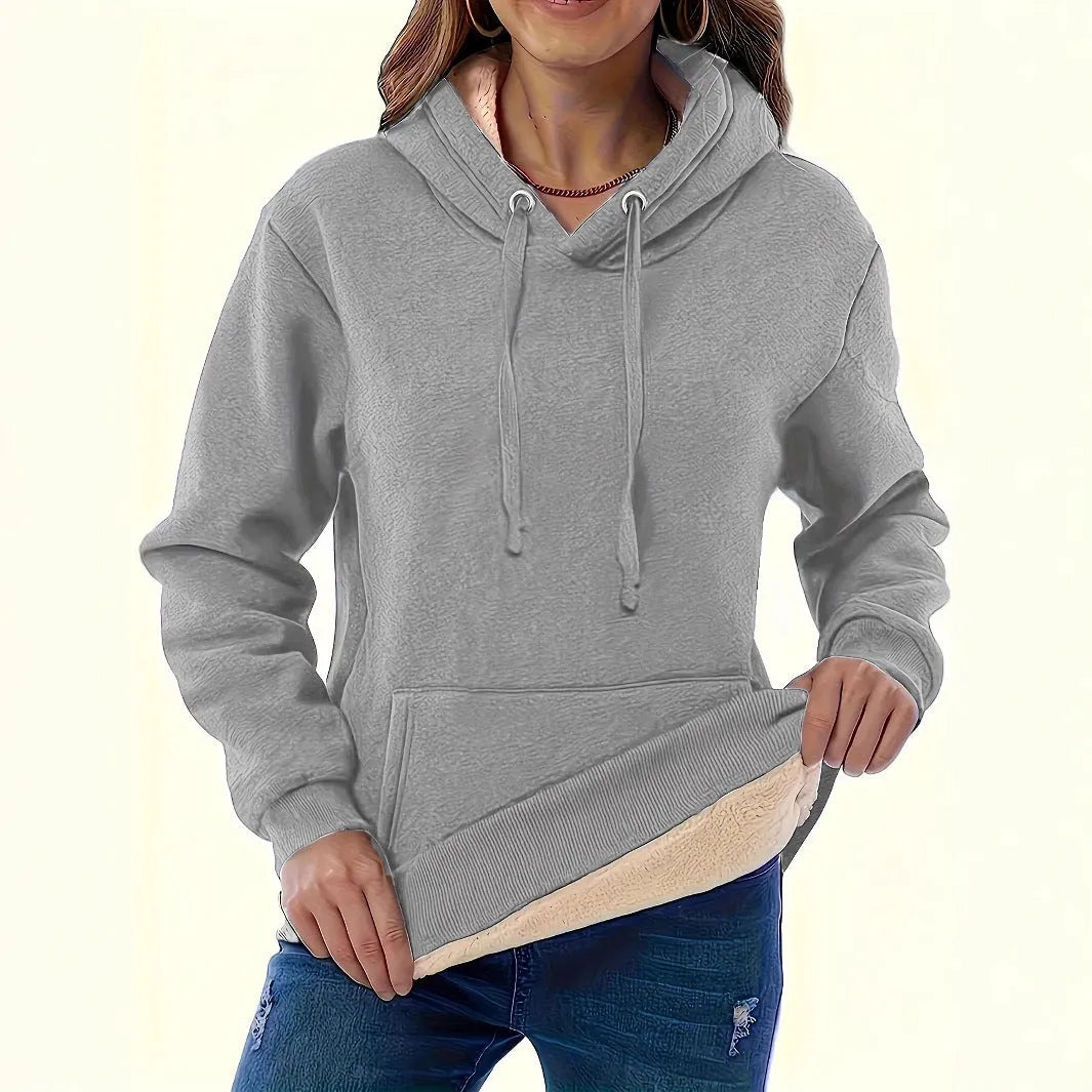 Women's loose-fit grey hooded sweater with a front pocket and a textured 3D pattern.