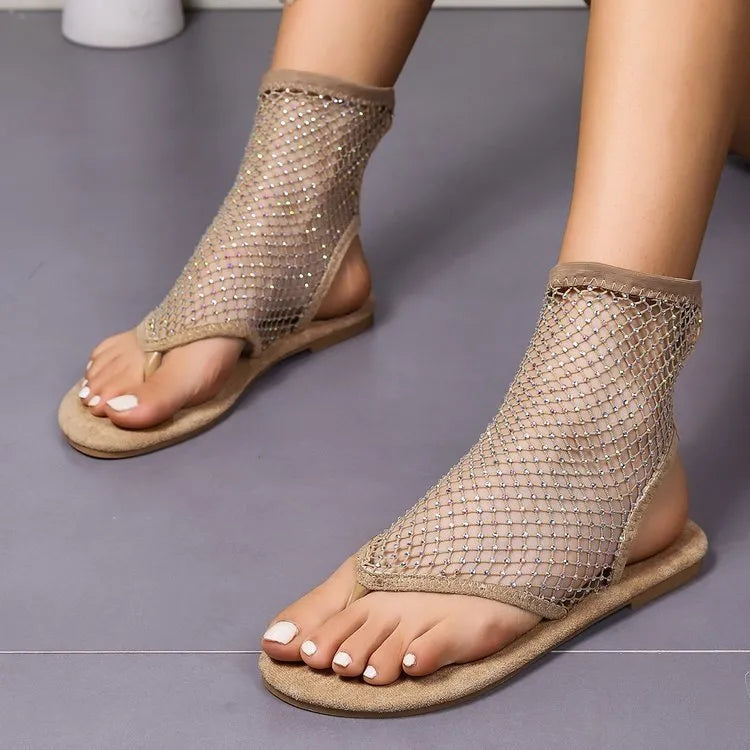 Women's rhinestone mesh thong sandals in beige with raw rubber sole and round toe on a flat surface