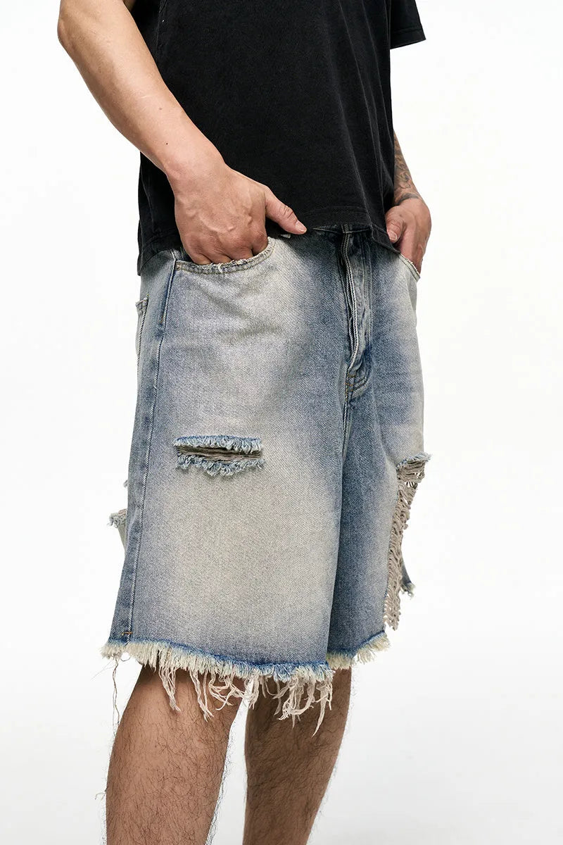 Light blue men's baggy denim shorts with a wide leg and retro washed finish on a mid-waist.