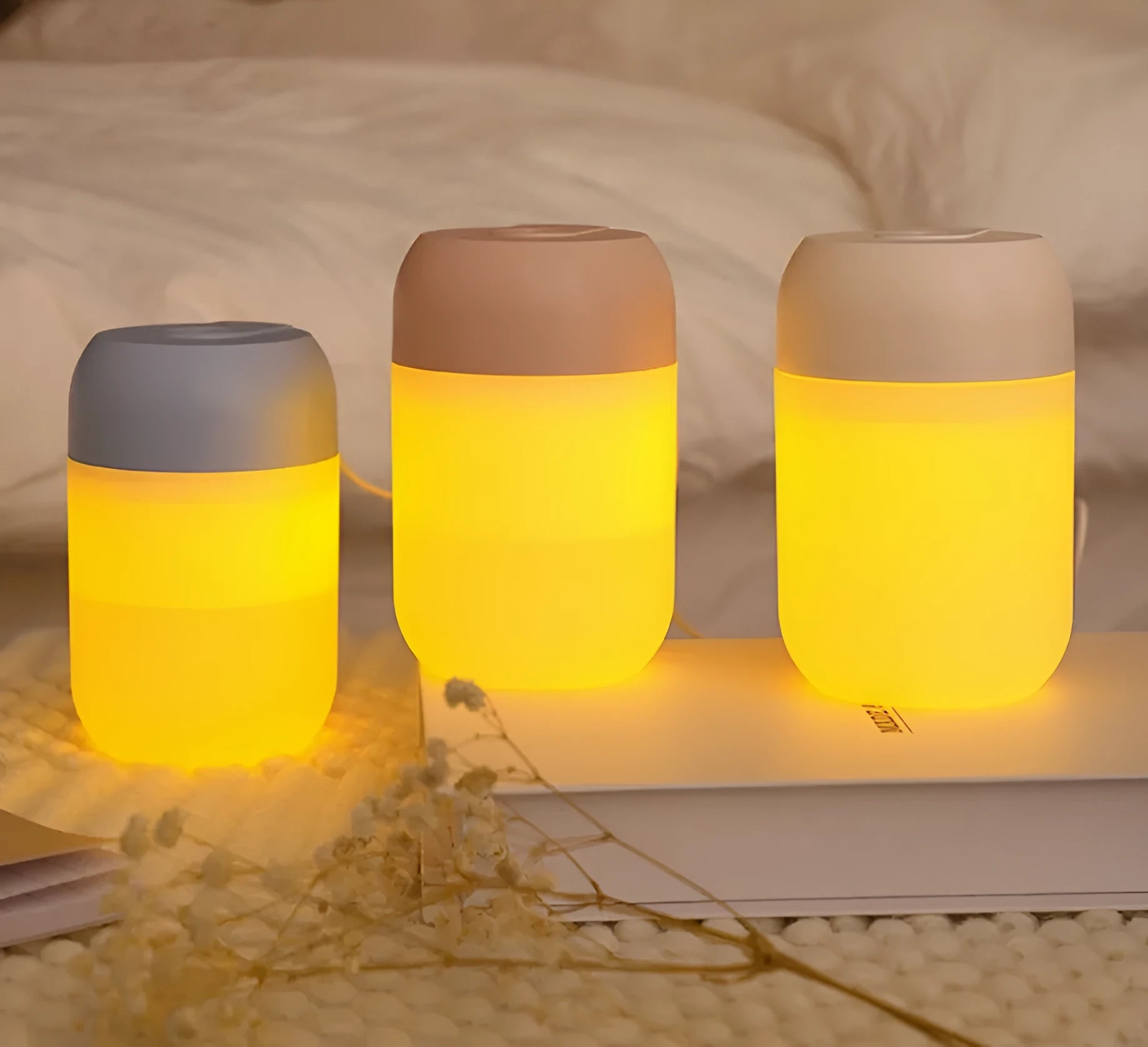 White cylindrical USB-powered mini humidifier on desk with charging cable