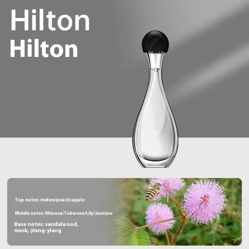 Ultrasonic aroma diffuser with mosquito repellent in a compact plastic design on a table, with essential oil bottle beside it