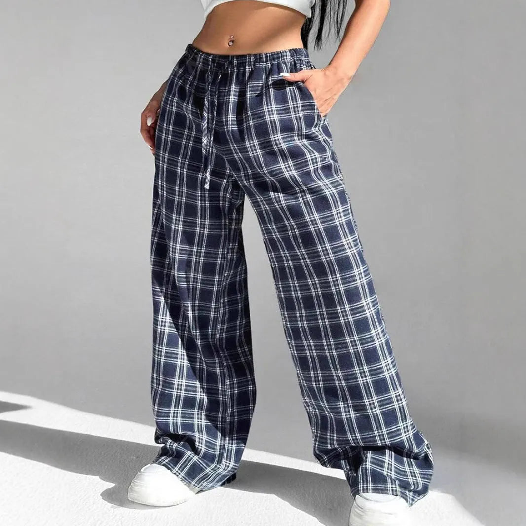Women's red plaid casual trousers with drawstring waist and side pockets laid flat