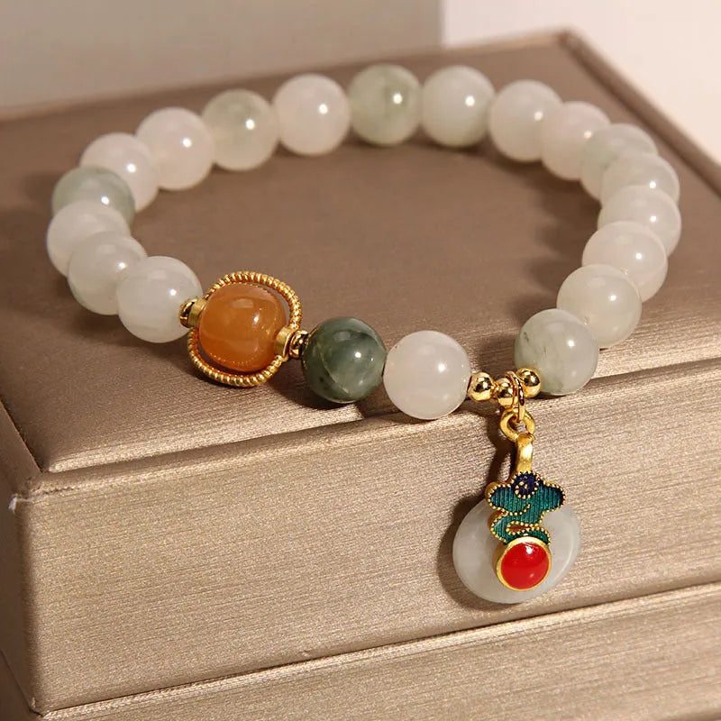 Women's Ice Jade jade bracelet with a Xiangyun peace buckle and pearl details on a white background.