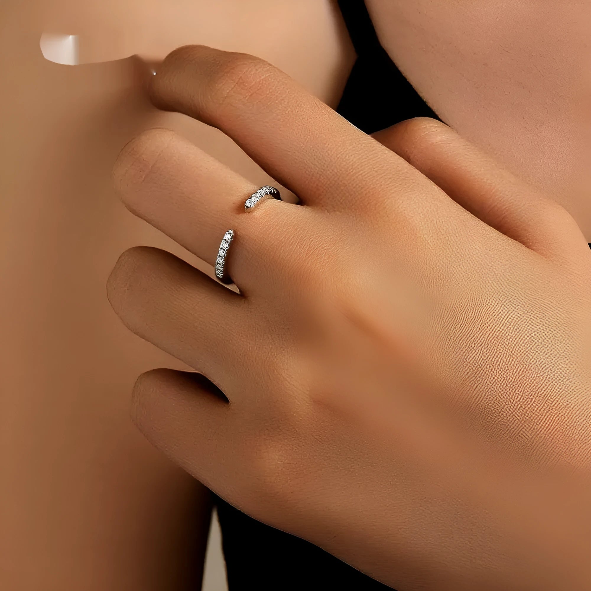 Silver adjustable geometry ring with electroplated platinum rehearsal diamond finish on finger