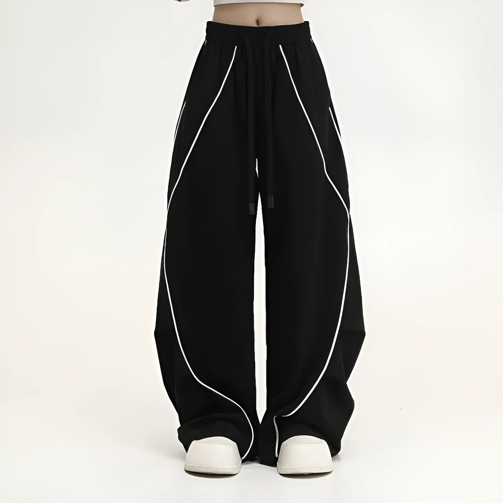 Black pleated wide-leg trousers with striped pattern showing mid-waist design and loose fit