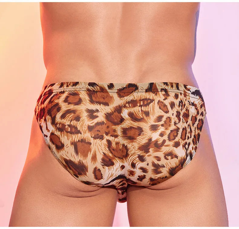 Men's leopard print low waist panties on a flat surface, showing the animal pattern design and brief cut.