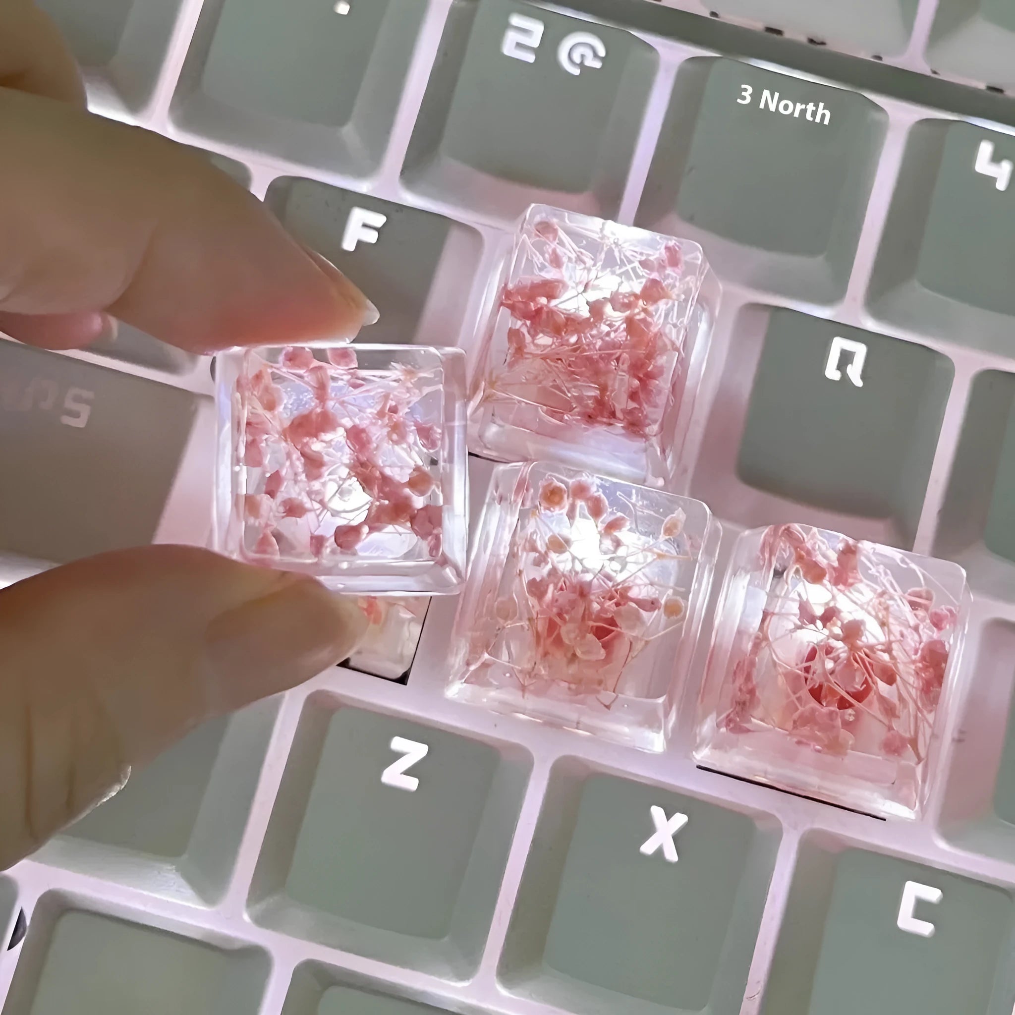 Transparent resin mechanical keyboard keycap showing starry sky galaxy design in multiple colour options