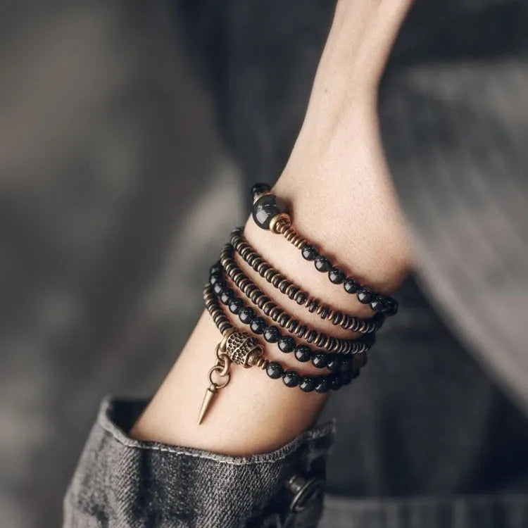 Unisex black beaded geometry multi-layered bracelet with natural style on plain background