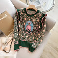 Women's green printed sweater with loose fit and regular sleeves shown on a model