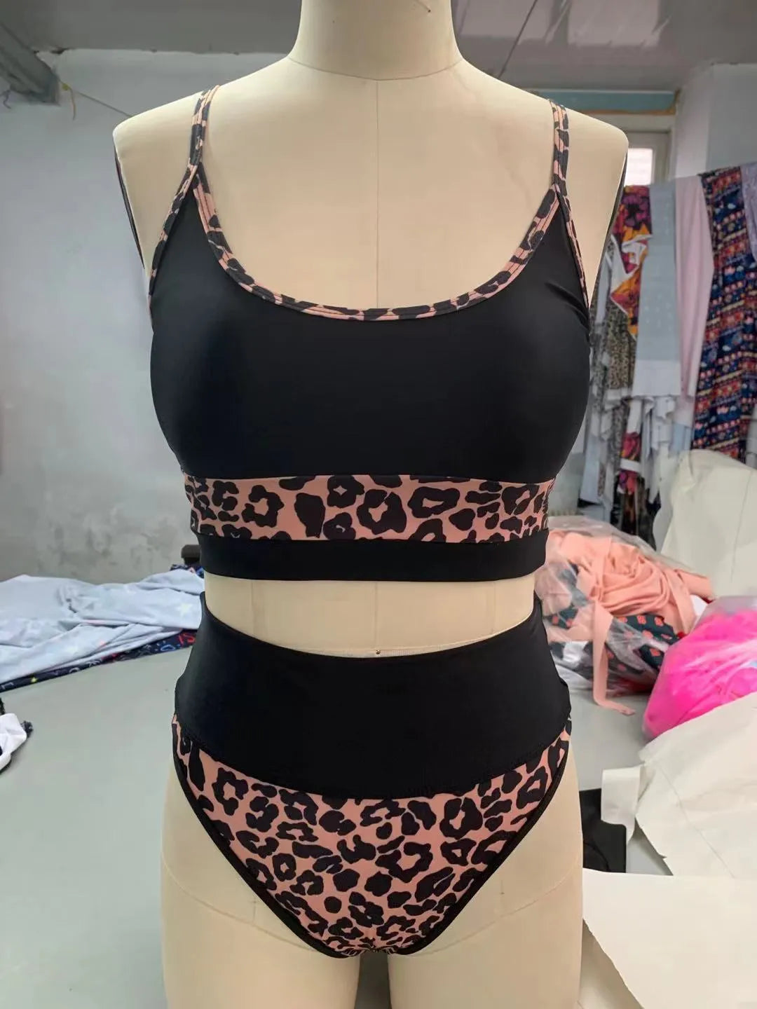 Women's high waist leopard print and white bikini swimsuit set on a mannequin