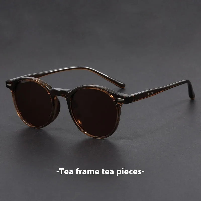 Ultra-light round frame retro sunglasses with polarised gray lenses in multiple colours including sand black, bright black, and gray
