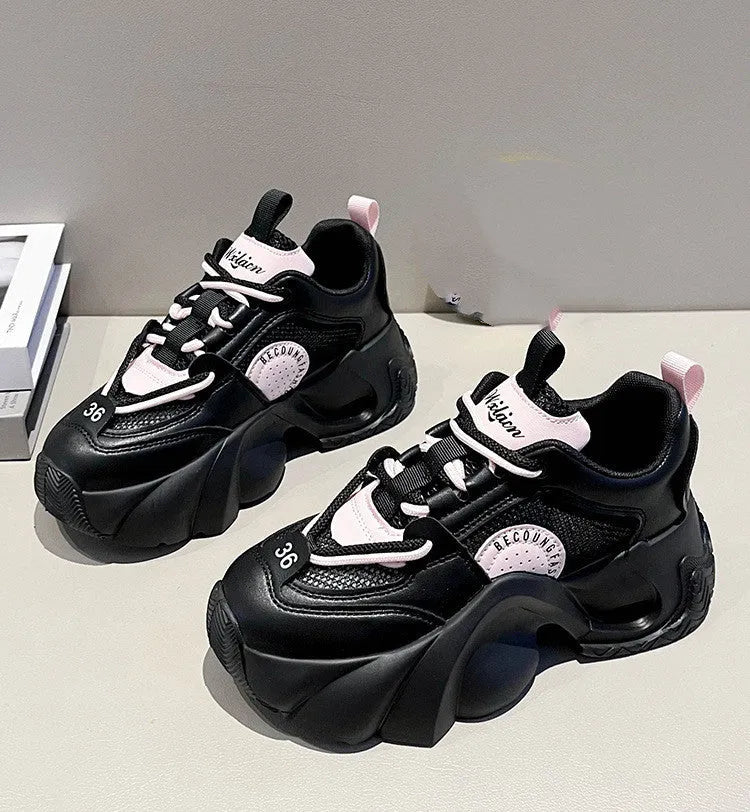 Women's pink casual sneakers with cross shoulder straps, thick sole, and mesh lining on a white background.