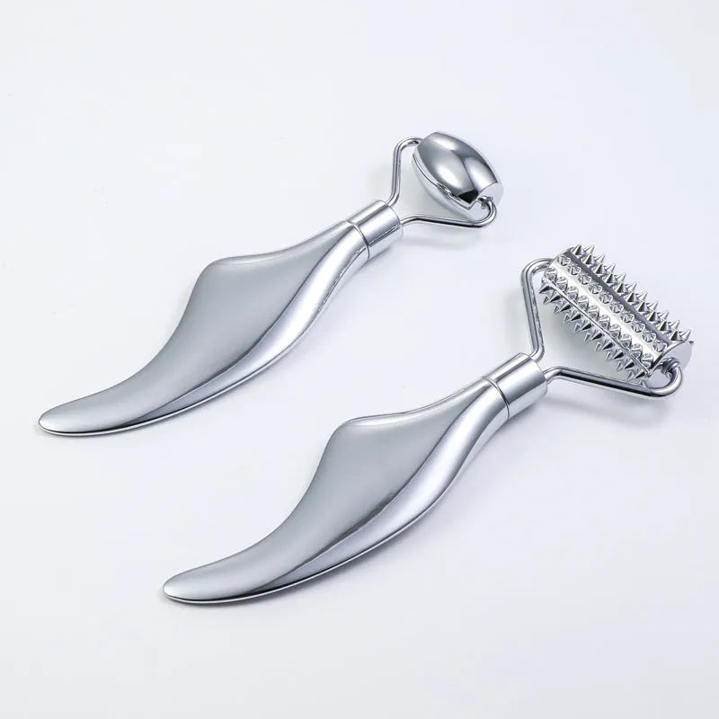 Stainless steel facial massage board set with heart-shaped eye roller and scraping plate on simple packaging