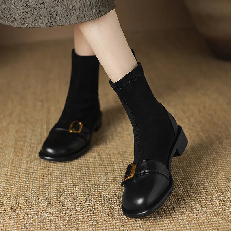 Black women's Martin-style ankle boots with lace-up front, round toe, and low heel on a white background.