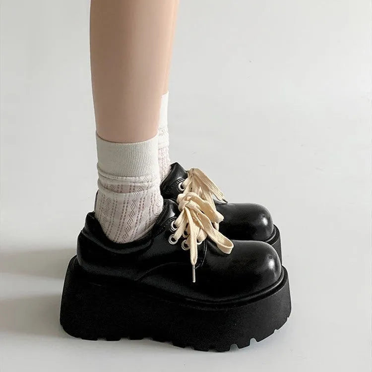 Women's matte black chunky heel lace-up shoes with a round toe and thick rubber sole.