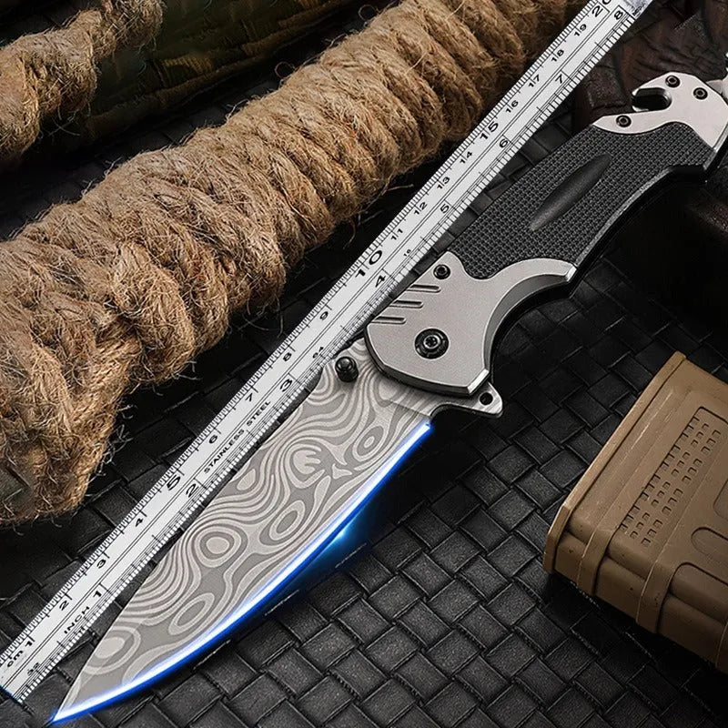 Portable folding knife with alloy blade, 225mm full length, on outdoor surface