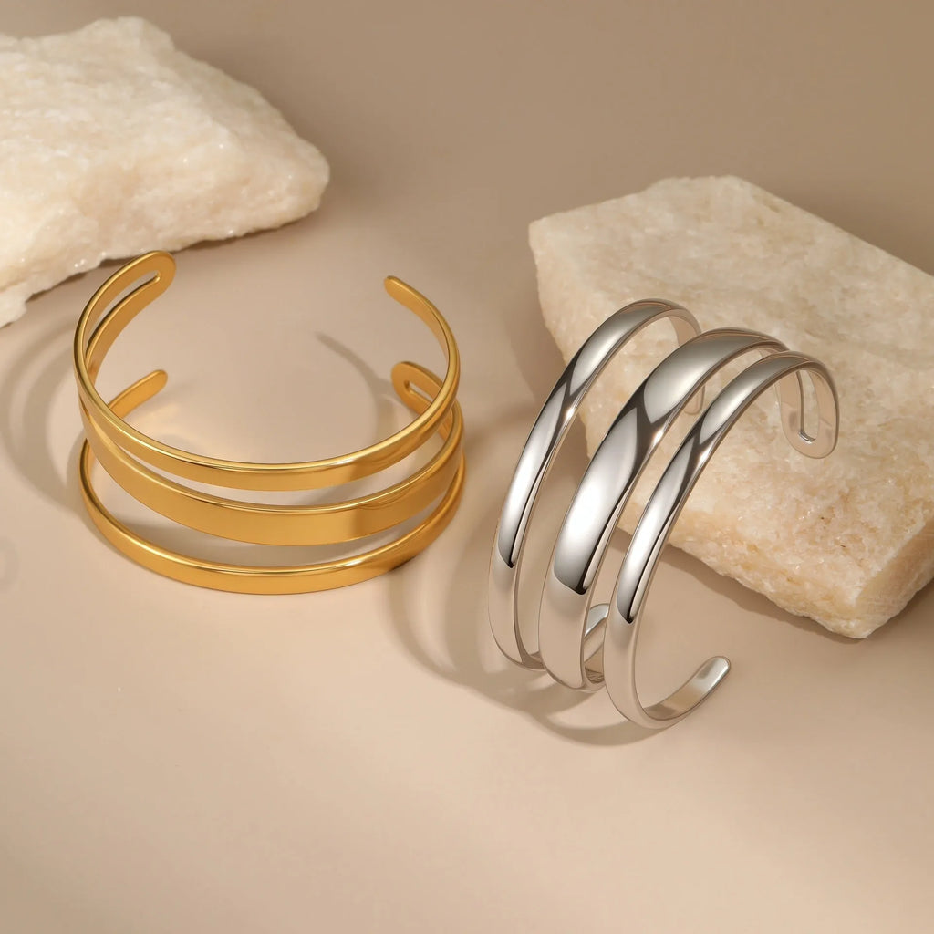 A simple open geometric stainless steel bracelet for women, shown in a gold tone finish.