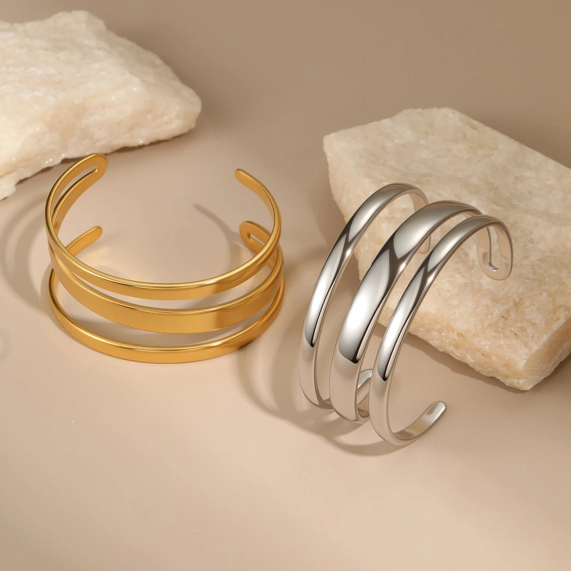 A simple open geometric stainless steel bracelet for women, shown in a gold tone finish.