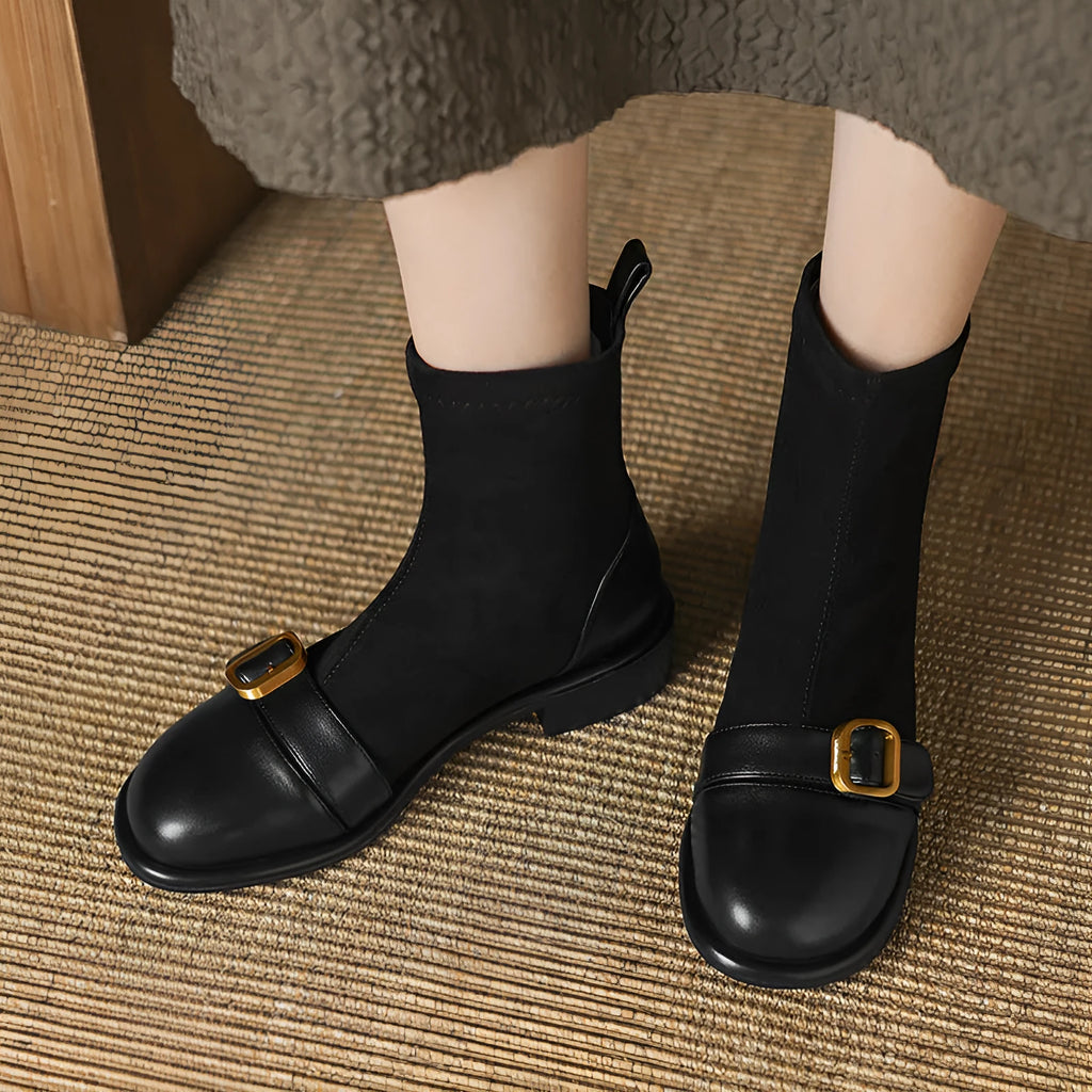 Black women's Martin-style ankle boots with lace-up front, round toe, and low heel on a white background.