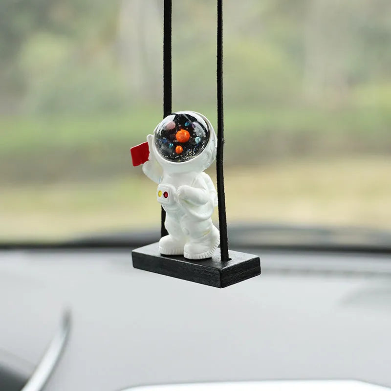 Resin astronaut car pendant with hand-painted cartoon designs in five colour variations