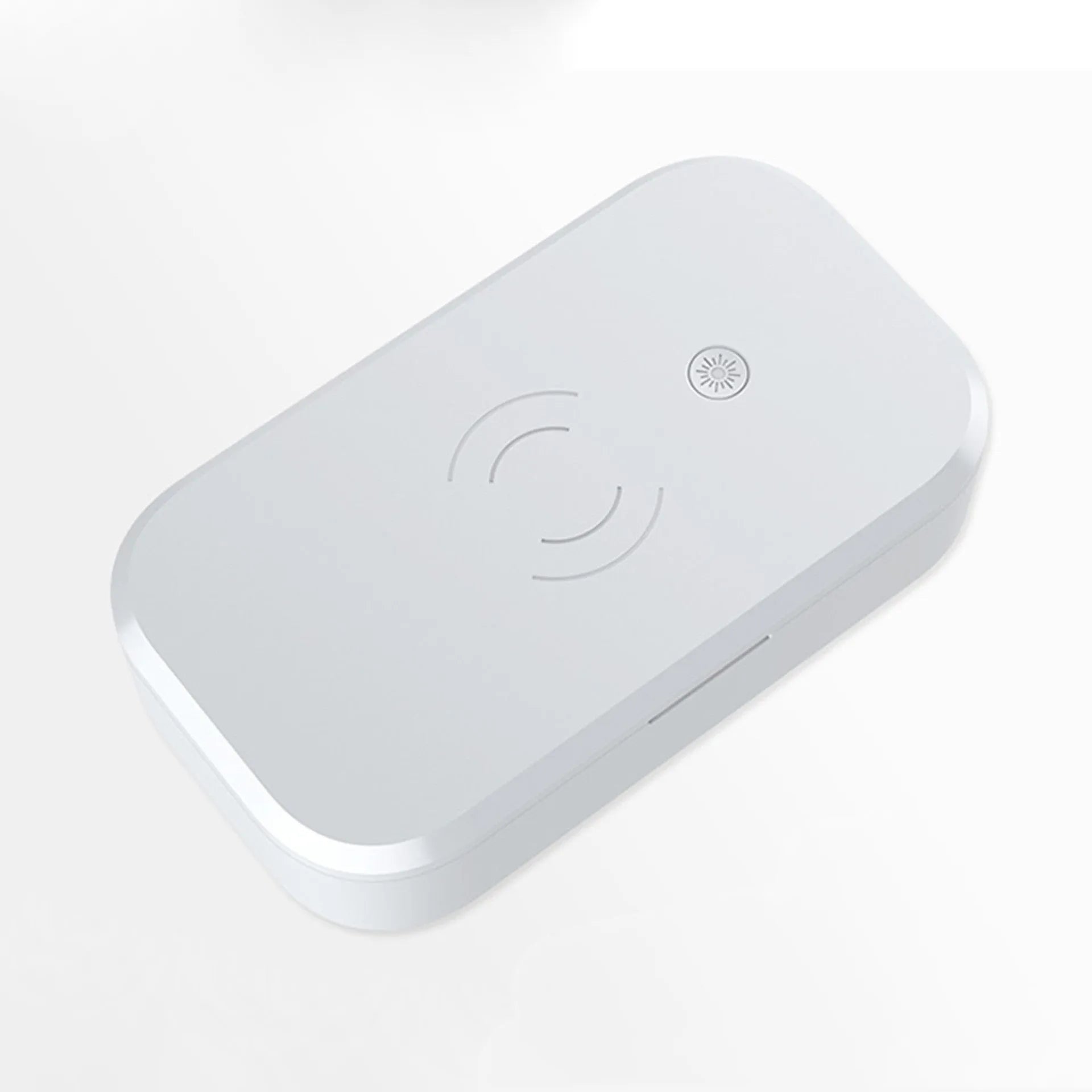 White ultraviolet disinfection box with wireless phone charger on top, shown with nail tools inside.
