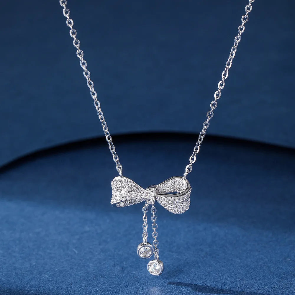 925 sterling silver necklace with a bow pendant on a silver O-ring chain.