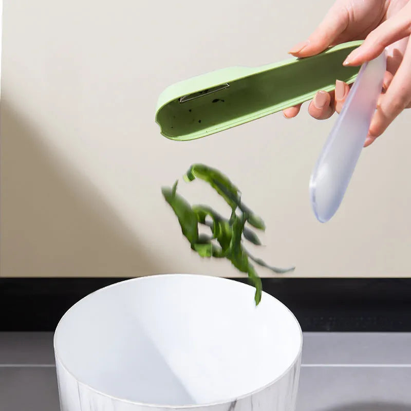 Dark green kitchen peeler with storage tube and stainless steel blade for fruits and vegetables