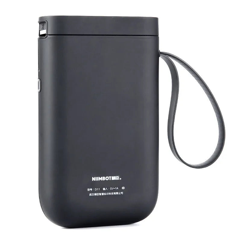 D11 compact black Bluetooth thermal label printer with LCD screen on a desk.