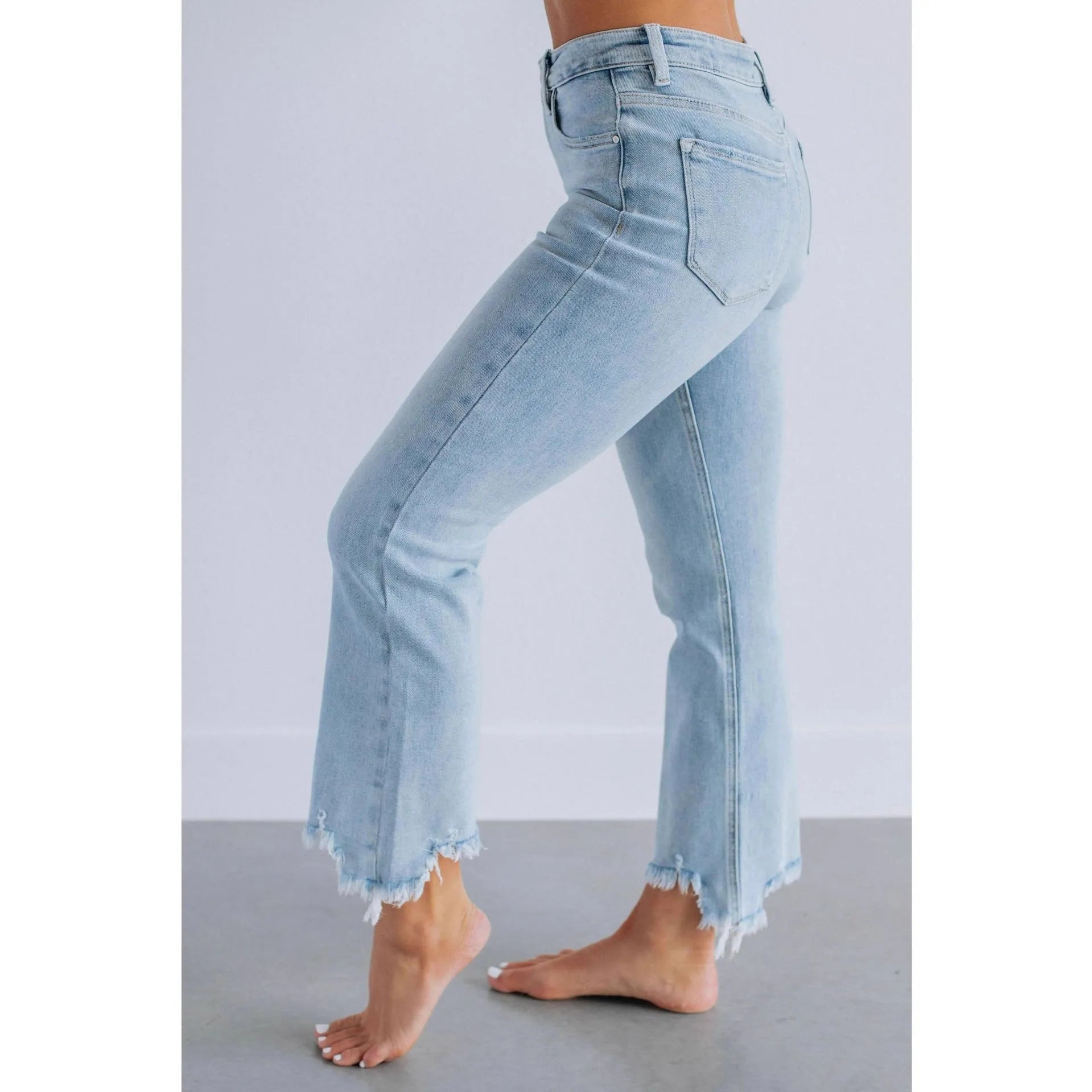 Women's solid colour denim jeans in dark blue and light blue, showing casual fit and hand-worn texture.