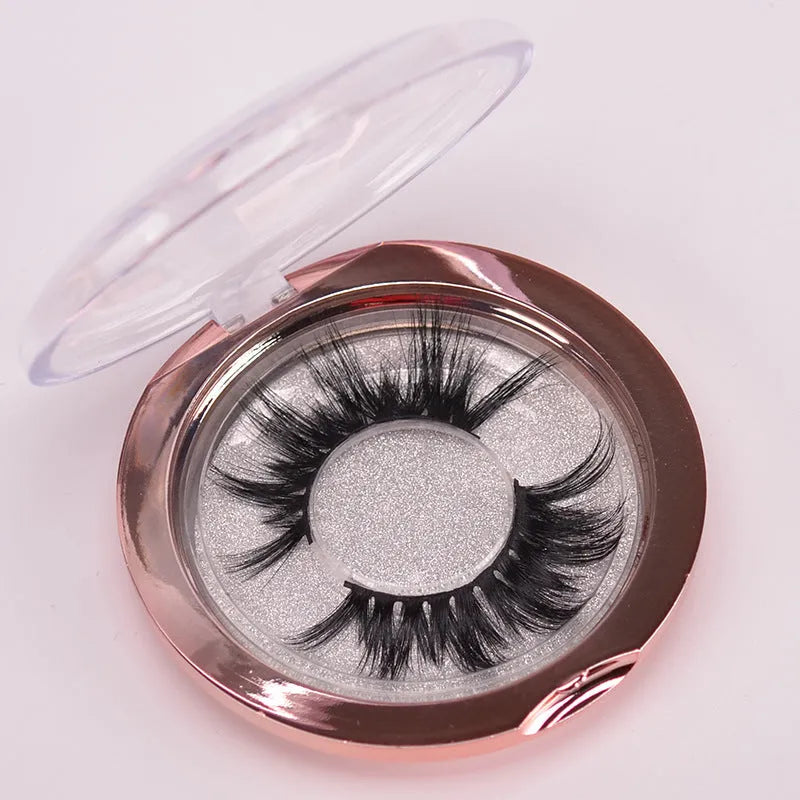 5D mink hair false eyelashes set with applicator brush and storage cap on white background