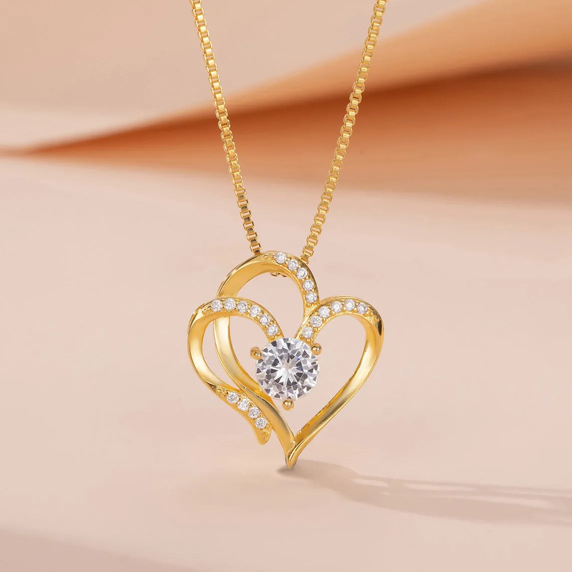 Women's sterling silver necklace with a heart-shaped pendant in rose gold, white gold, or yellow gold finish.